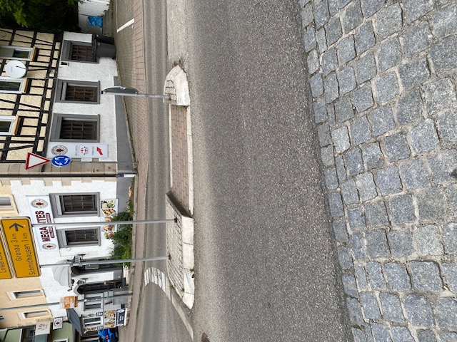Fußgängerüberweg am Kreisverkehr mit Insel zwischen den Fahrspuren, ohne Kennzeichnung und ohne taktile Elemente 